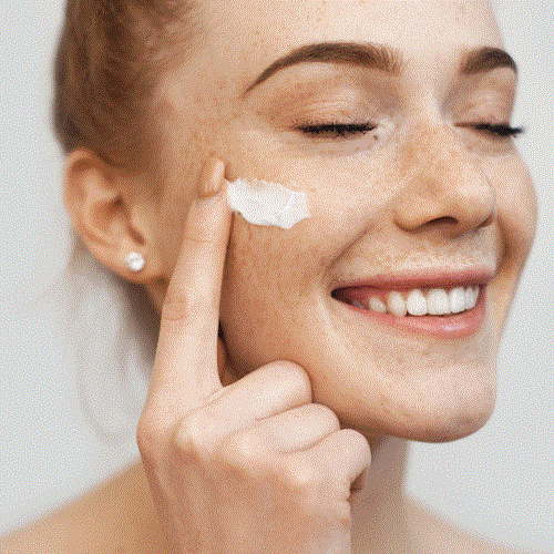 woman is testing torriden moisture sun cream on her face 